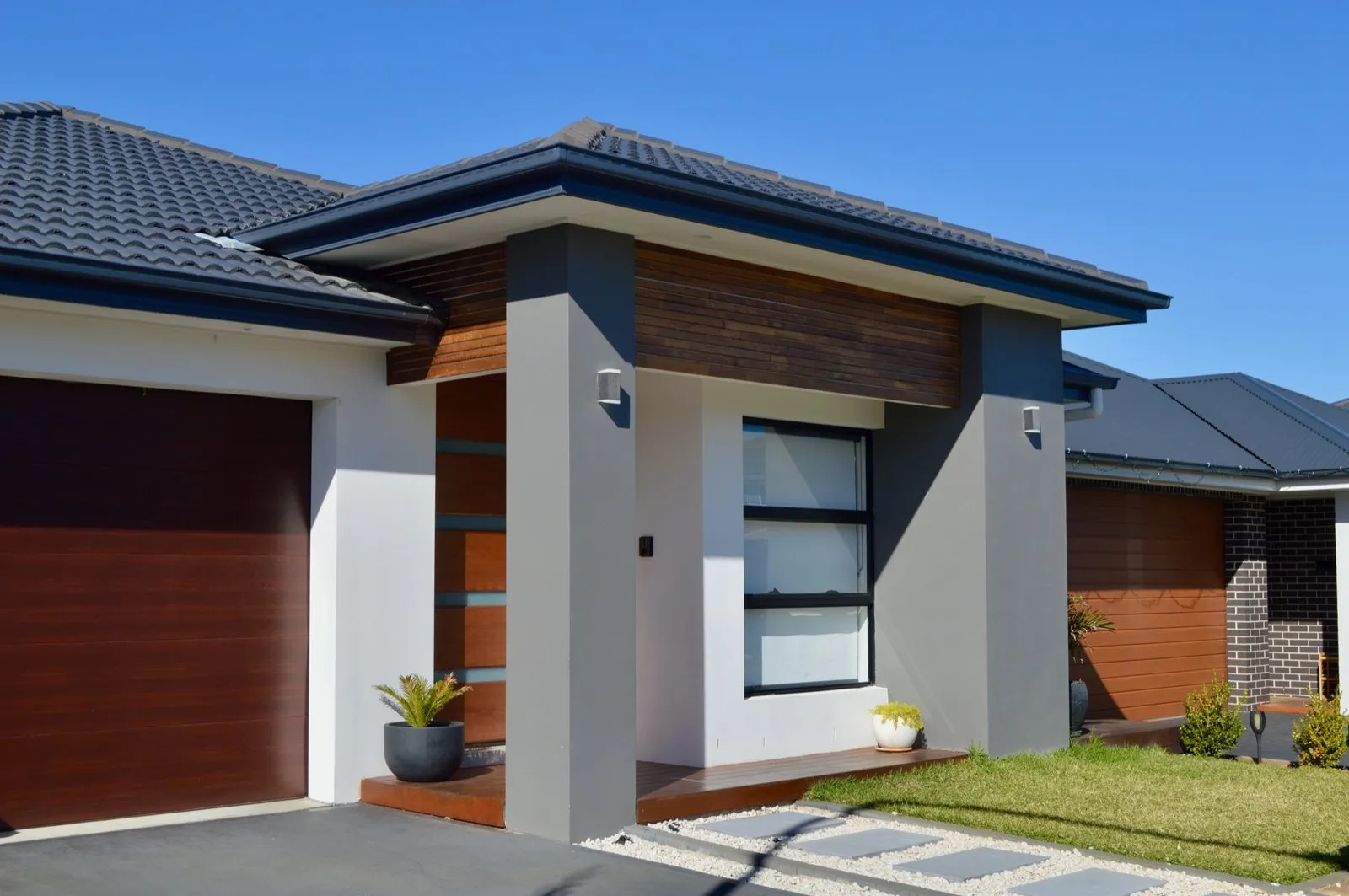 Entry portico detail on a narrow frontage home showing the front setback and facade articulation